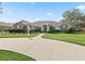 Charming single-story home boasts vibrant blue shutters, a well-manicured lawn, and an inviting entrance at 10230 Barrington Ct, Leesburg, FL 34788