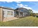 Exterior view of the pool and lanai area, showcasing the spacious backyard and lake views at 10606 Masters Dr, Clermont, FL 34711