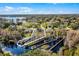 Beautiful aerial view of property with lake, lush trees, dock and waterfront footage at 11101 Versailles Blvd, Clermont, FL 34711