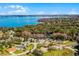 Breathtaking aerial view of homes in a lakeside community, featuring waterfront access and lush greenery at 11101 Versailles Blvd, Clermont, FL 34711