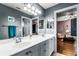 Bathroom with double vanity and undermount sinks plus a view into the bedroom at 11101 Versailles Blvd, Clermont, FL 34711