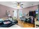 Bedroom features a ceiling fan, wood floors, and a window with natural light at 11101 Versailles Blvd, Clermont, FL 34711