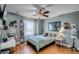 Stylized bedroom with ceiling fan, desk, decor, wood floors, and window with natural light at 11101 Versailles Blvd, Clermont, FL 34711