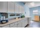 Well-organized laundry room with ample storage, modern washer/dryer, and stylish countertops at 11101 Versailles Blvd, Clermont, FL 34711