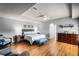 Spacious main bedroom with a tray ceiling, wood floors, sitting area and a dresser at 11101 Versailles Blvd, Clermont, FL 34711