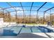 This is a covered pool with a seating area overlooking a lush yard at 11101 Versailles Blvd, Clermont, FL 34711