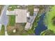 Aerial view of the home with a large backyard and water feature at 1119 Cr 457, Lake Panasoffkee, FL 33538