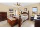 Bedroom featuring a wood bed frame, tiled floors, and natural light at 1119 Cr 457, Lake Panasoffkee, FL 33538