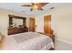 Cozy bedroom with wood furniture, tiled floors, and ceiling fan at 1119 Cr 457, Lake Panasoffkee, FL 33538