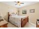 Cozy bedroom showcasing a wooden bed frame and a sunlit window with peaceful outdoor views at 1119 Cr 457, Lake Panasoffkee, FL 33538