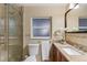 Bathroom with a glass-enclosed shower and granite countertop vanity at 11243 Dead River Rd, Tavares, FL 32778