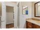 Bathroom featuring a granite countertop, wood cabinets, and walk-in shower at 11243 Dead River Rd, Tavares, FL 32778