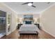 Bedroom with a view to the outdoor living area at 11243 Dead River Rd, Tavares, FL 32778