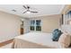 This bedroom has a water view, neutral paint, and a doorway to an en suite bathroom at 11243 Dead River Rd, Tavares, FL 32778