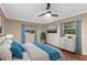 This bedroom has two windows, neutral paint, and a modern ceiling fan at 11243 Dead River Rd, Tavares, FL 32778