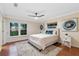 The bedroom features a large window with water views, neutral paint, and a light-colored padded headboard at 11243 Dead River Rd, Tavares, FL 32778