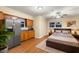 This bedroom has a kitchen area, neutral paint, and hardwood floors at 11243 Dead River Rd, Tavares, FL 32778