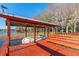 Picturesque boat dock featuring a boat lift, seating, and a waterfront view surrounded by lush trees at 11243 Dead River Rd, Tavares, FL 32778