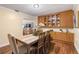 Dining room with a wooden table and chairs, wood floors and glass-front cabinets at 11243 Dead River Rd, Tavares, FL 32778