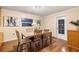 Dining room with wood table and chairs, adjacent to a window and doorway at 11243 Dead River Rd, Tavares, FL 32778