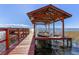 Private dock boasts a covered boat lift and ample space, perfect for accessing the lake and enjoying waterfront living at 11243 Dead River Rd, Tavares, FL 32778