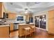 This kitchen features natural wood cabinets, stainless appliances, an island, and access to an outdoor deck at 11243 Dead River Rd, Tavares, FL 32778