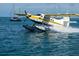 Seaplane splashing down in the water, illustrating Tavares as 