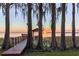 Beautiful waterfront view at sunset with dock and boat access on a serene lake setting at 11243 Dead River Rd, Tavares, FL 32778