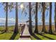 Waterfront property with dock, gazebo, and lush greenery at 11243 Dead River Rd, Tavares, FL 32778