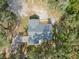 Overhead aerial shot of home displaying new roof, backyard deck, expansive yard, and tree coverage at 12220 County Road 209, Oxford, FL 34484