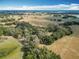 Picturesque aerial shot of land featuring green trees, expansive fields and a blue sky with clouds at 12220 County Road 209, Oxford, FL 34484