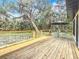 Large deck with table and chairs overlooking a grassy field at 12220 County Road 209, Oxford, FL 34484