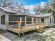 Beautiful backyard deck featuring modern railings, seating, and umbrella for outdoor relaxation at 12220 County Road 209, Oxford, FL 34484