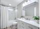 Bathroom featuring a shower-tub combo and a vanity with a white marble countertop at 12220 County Road 209, Oxford, FL 34484