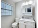 Bathroom featuring white vanity with marble countertop and a large window at 12220 County Road 209, Oxford, FL 34484