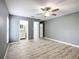 Spacious bedroom featuring wood-look flooring and ceiling fan light fixture at 12220 County Road 209, Oxford, FL 34484