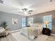 A stylish bedroom featuring a ceiling fan, soft rug, comfortable bed, and modern decor at 12220 County Road 209, Oxford, FL 34484