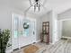 Bright entryway featuring decorative front door, hall tree and luxury vinyl flooring at 12220 County Road 209, Oxford, FL 34484