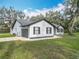 Home exterior featuring an attached two-car garage and clean landscaping at 12220 County Road 209, Oxford, FL 34484