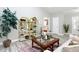 Bright living room with modern decor, decorative shelving, and sleek wood flooring at 12220 County Road 209, Oxford, FL 34484