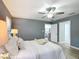 Cozy bedroom features a ceiling fan, neutral decor, and bright lighting at 12220 County Road 209, Oxford, FL 34484