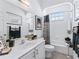 Bathroom featuring a white vanity, black and white accents and a tub and shower with a patterned curtain at 12390 Se 176Th Loop, Summerfield, FL 34491