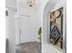 Bright foyer with tile flooring, decorative artwork, and a view of the front door, welcoming guests into the home at 12390 Se 176Th Loop, Summerfield, FL 34491