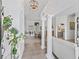 Elegant foyer with tile flooring, white columns, and a view into the dining room and living spaces, creating a grand entrance at 12390 Se 176Th Loop, Summerfield, FL 34491