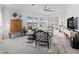 Bright living room with a gray sofa, unique chairs, and decor that compliments the natural light from the many windows at 12390 Se 176Th Loop, Summerfield, FL 34491