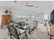 Bright living room with a gray sofa, unique chairs, and a decorative mirror wall that enhances the natural light at 12390 Se 176Th Loop, Summerfield, FL 34491