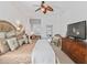 Well-lit main bedroom with a decorative fan, comfortable seating, and natural light, and a warm color palette at 12390 Se 176Th Loop, Summerfield, FL 34491