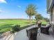 Beautiful patio overlooking a lush golf course with a mature palm tree in the backyard at 12390 Se 176Th Loop, Summerfield, FL 34491