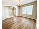 Inviting dining room with wood floors, chandelier, and arched doorway at 1263 Legendary Blvd, Clermont, FL 34711