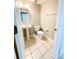 Convenient powder room with pedestal sink and tile flooring at 1263 Legendary Blvd, Clermont, FL 34711